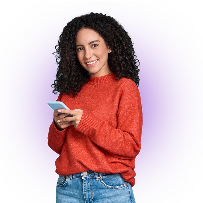 Smiling woman, wearing a red sweater, holding a smartphone in her hand